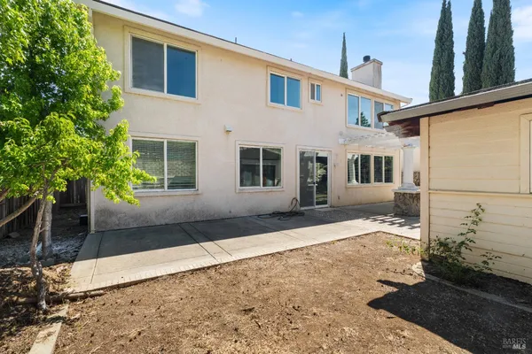 a view of a house with backyard and sitting area
