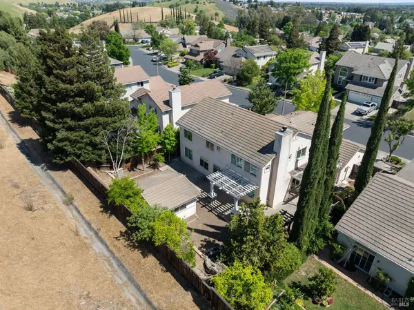 an aerial view of a house with garden space and street view