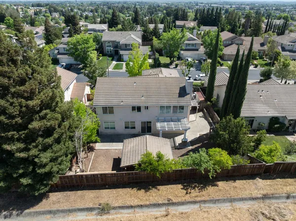 an aerial view of a house with outdoor space