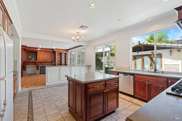 a kitchen with stainless steel appliances granite countertop a sink and a counter