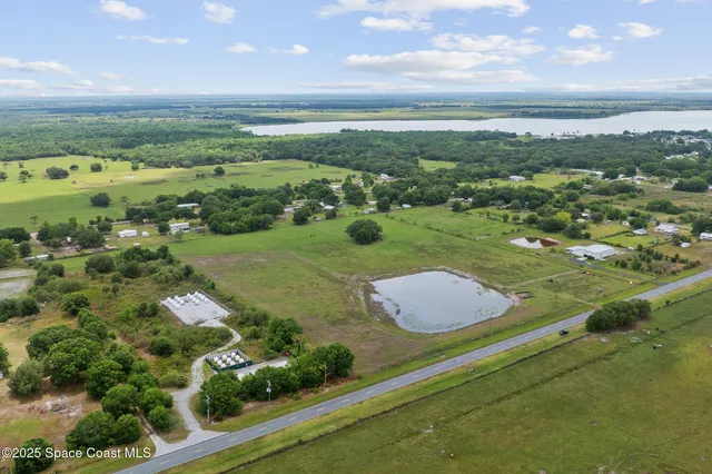 an aerial view of a golf course with parking space