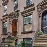 a front view of a house with large windows