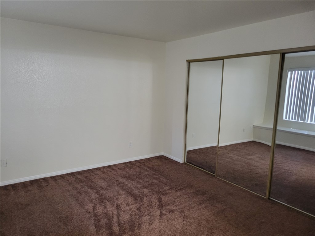 9325 West Desert Inn Road, Unit 178 Las Vegas, NV 89117 - Photo 9 of 20 Plush carpeting anchors this bedroom featuring sliding mirrored closet doors.