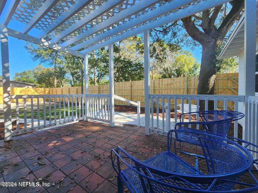 7269 Balboa Road Jacksonville, FL 32217 - Photo 14 of 24 a view of a patio with a table chairs and a backyard