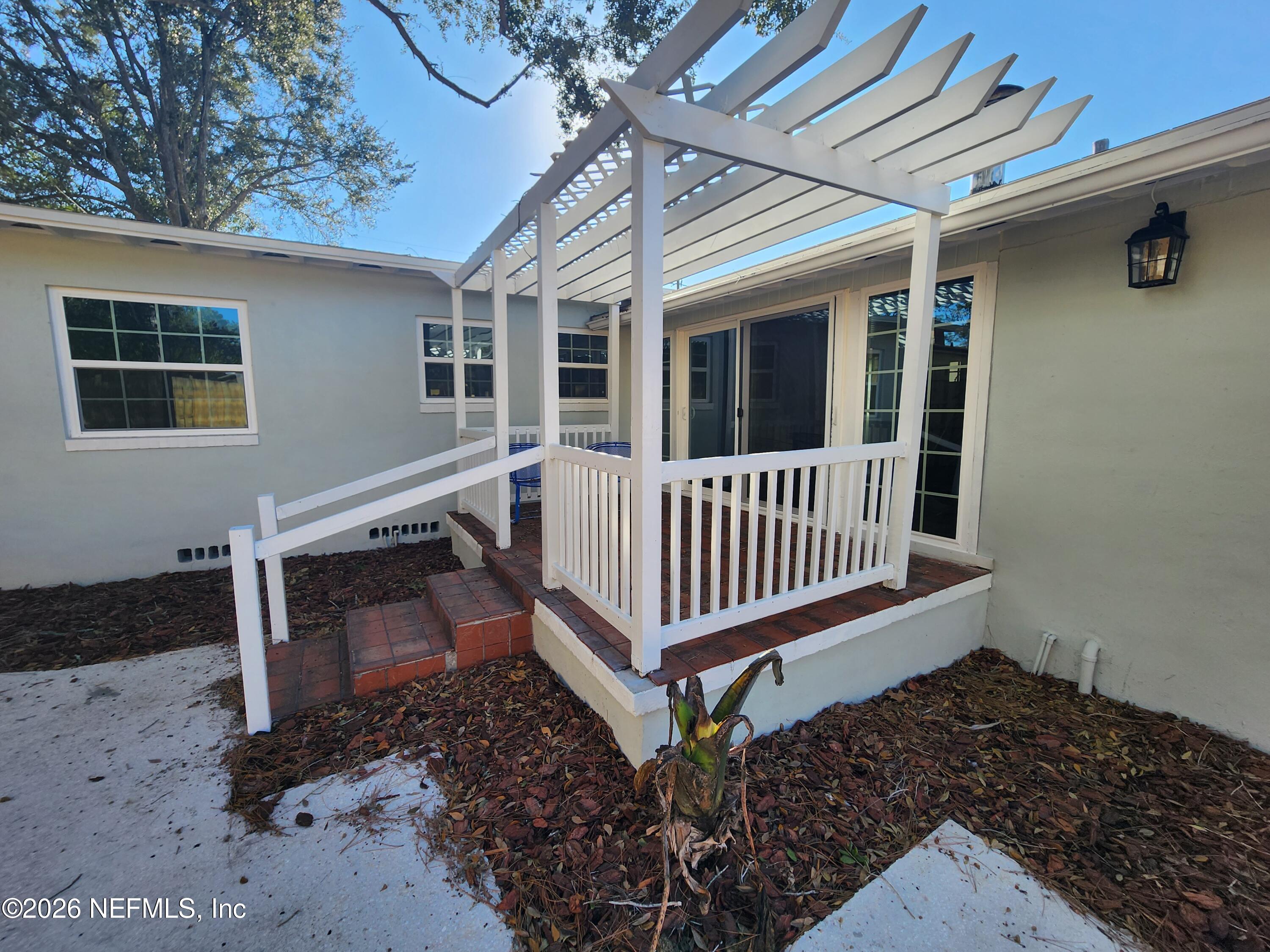 7269 Balboa Road Jacksonville, FL 32217 - Photo 22 of 24 a porch with stairs and a yard
