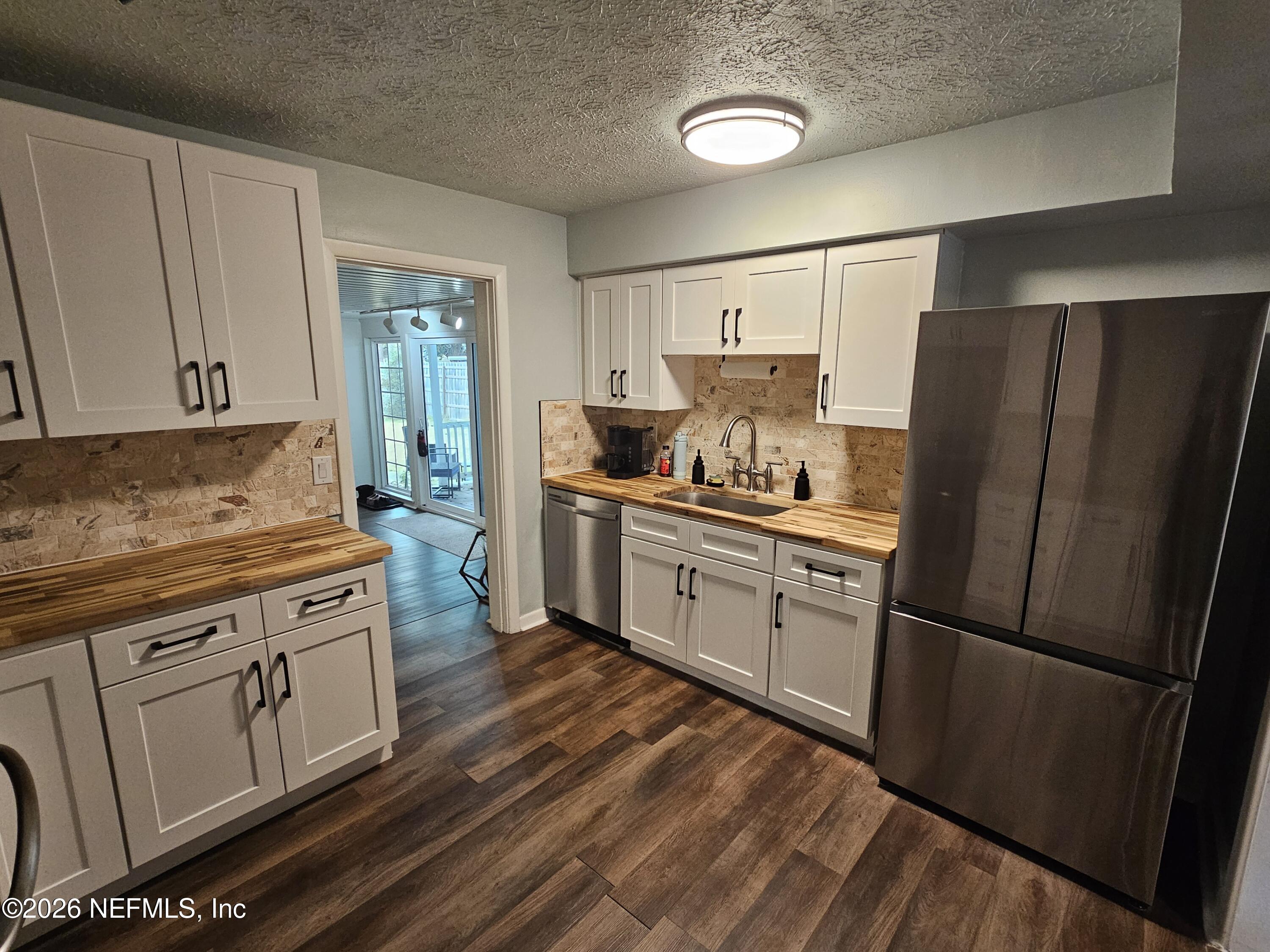 7269 Balboa Road Jacksonville, FL 32217 - Photo 8 of 24 a kitchen with stainless steel appliances a refrigerator stove and sink