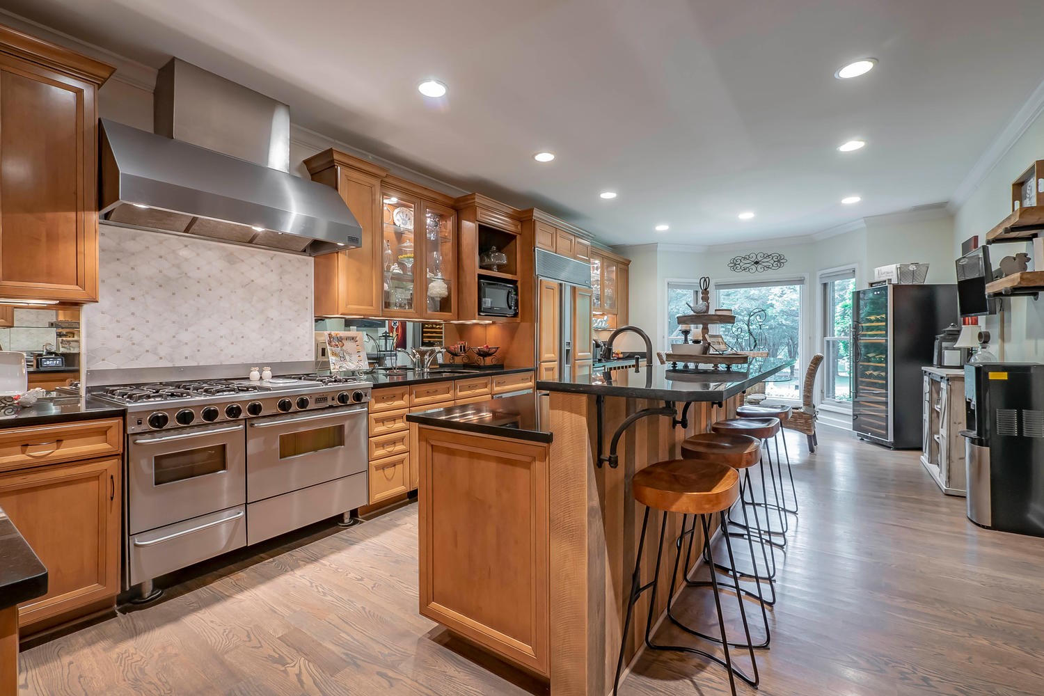 5922 Cane Ridge Road Antioch, TN 37013 - Photo 15 of 50 a kitchen with stainless steel appliances granite countertop table chairs stove and wooden floor