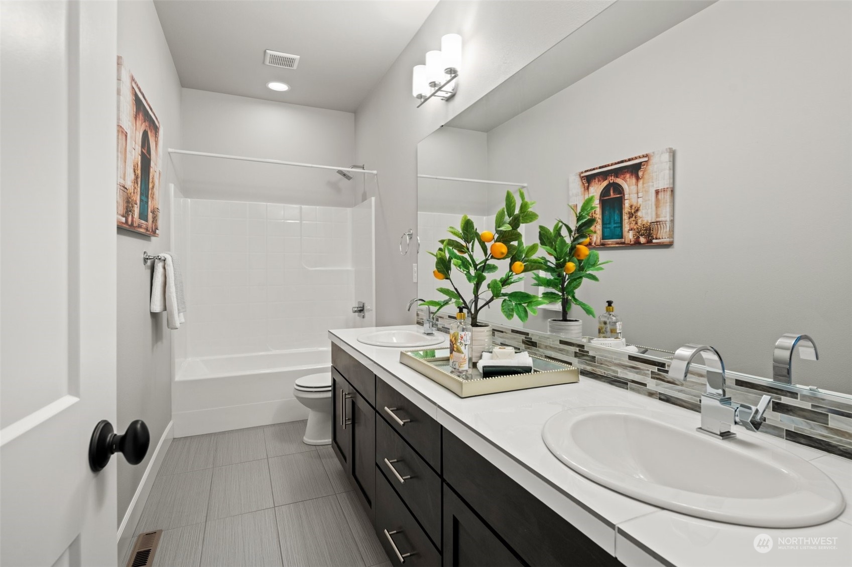 24213 1st Avenue Southeast Bothell, WA 98021 - Photo 27 of 32 a bathroom with a double vanity sink and a mirror