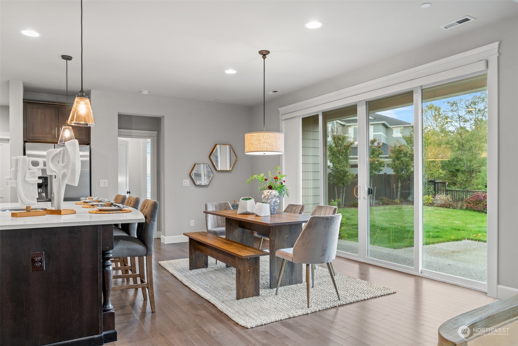 24213 1st Avenue Southeast Bothell, WA 98021 - Photo 9 of 32 a dining room with furniture a chandelier and wooden floor