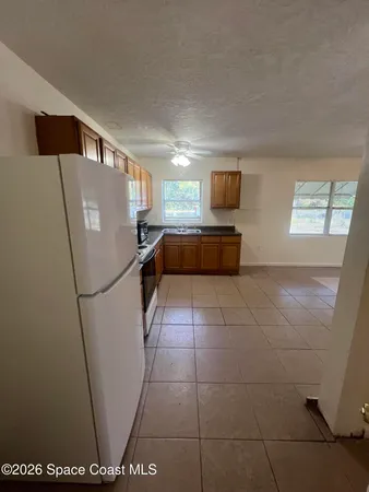 a room with a refrigerator and a window