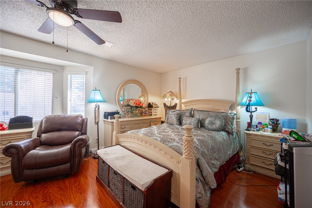 718 Rusty Spur Drive Henderson, NV 89014 - Photo 45 of 50 Hardwood floors and ample natural light define this cozy primary suite retreat.