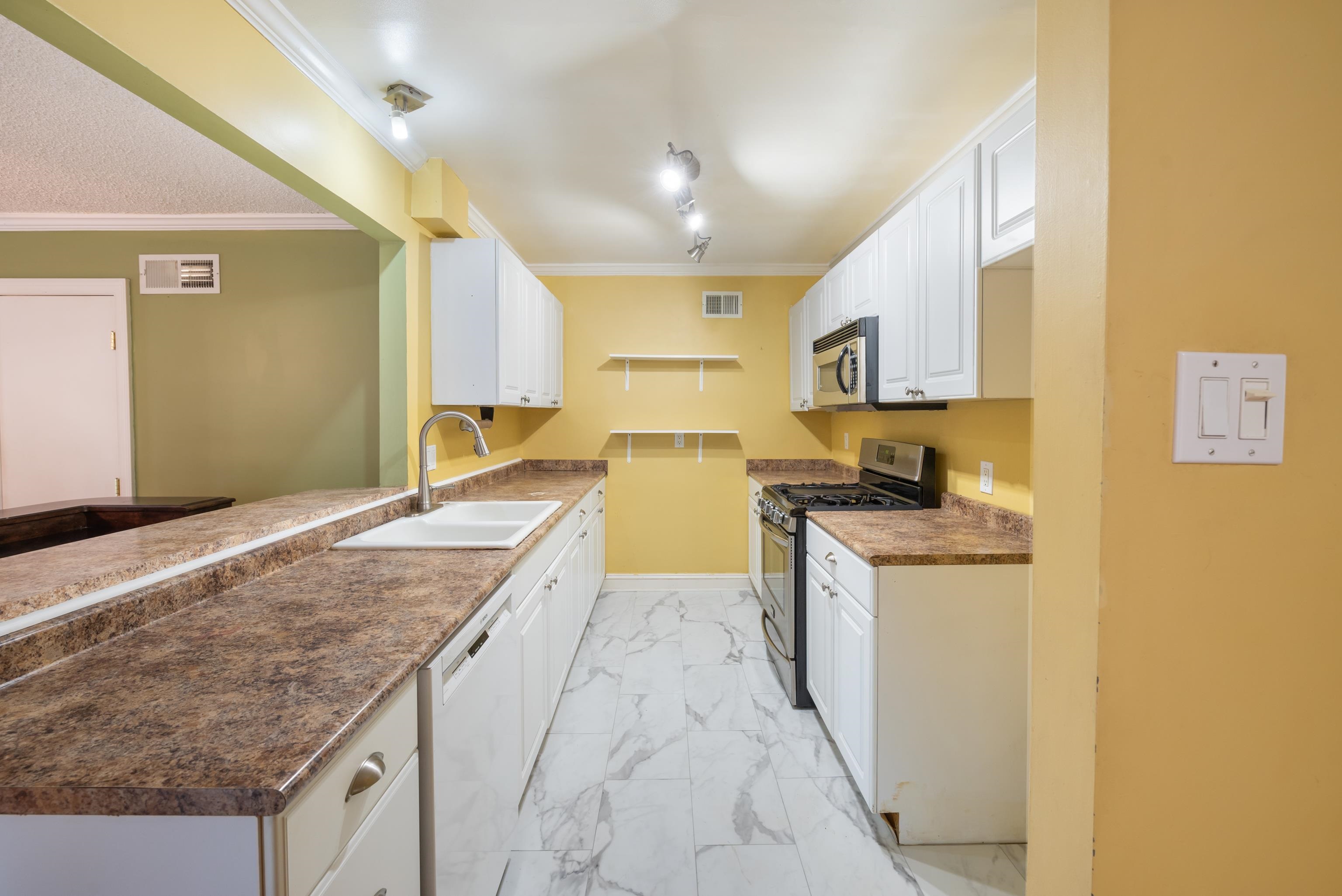 4461 Princeton Road Memphis, TN 38117 - Photo 8 of 33 a kitchen with granite countertop a stove and a sink