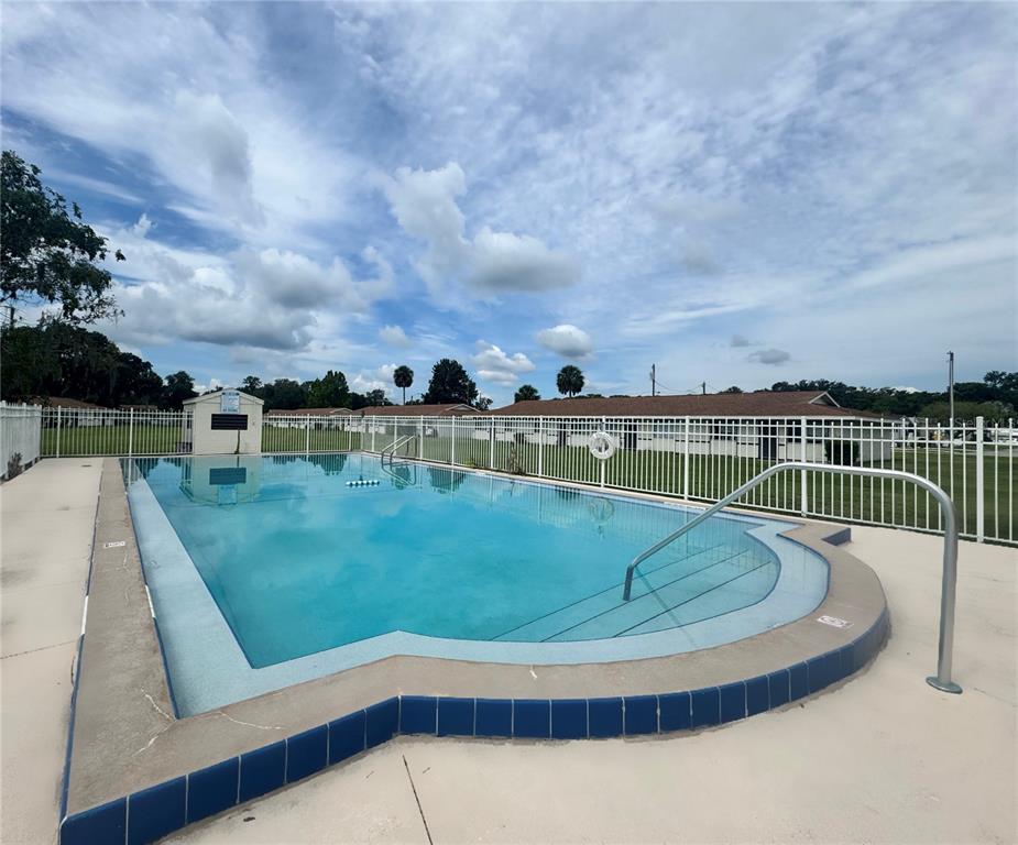 2744 Botts Landing Road, Unit 702 DeLand, FL 32720 - Photo 12 of 12 a view of a swimming pool with a yard