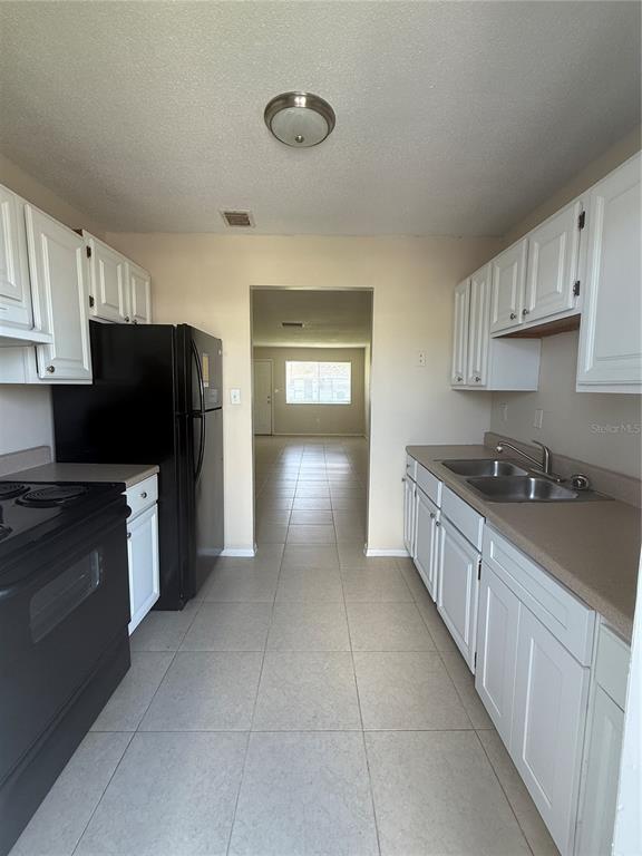 2744 Botts Landing Road, Unit 702 DeLand, FL 32720 - Photo 2 of 12 a kitchen with stainless steel appliances granite countertop a refrigerator a stove top oven a sink and dishwasher