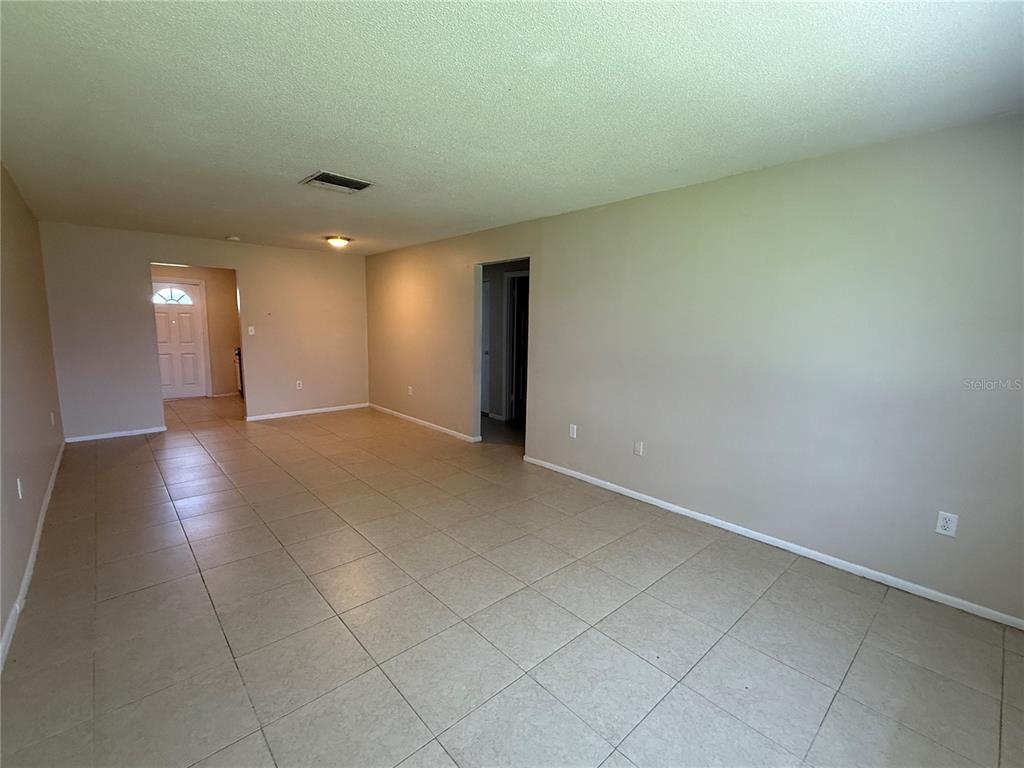 2744 Botts Landing Road, Unit 702 DeLand, FL 32720 - Photo 6 of 12 an empty room with a natural light