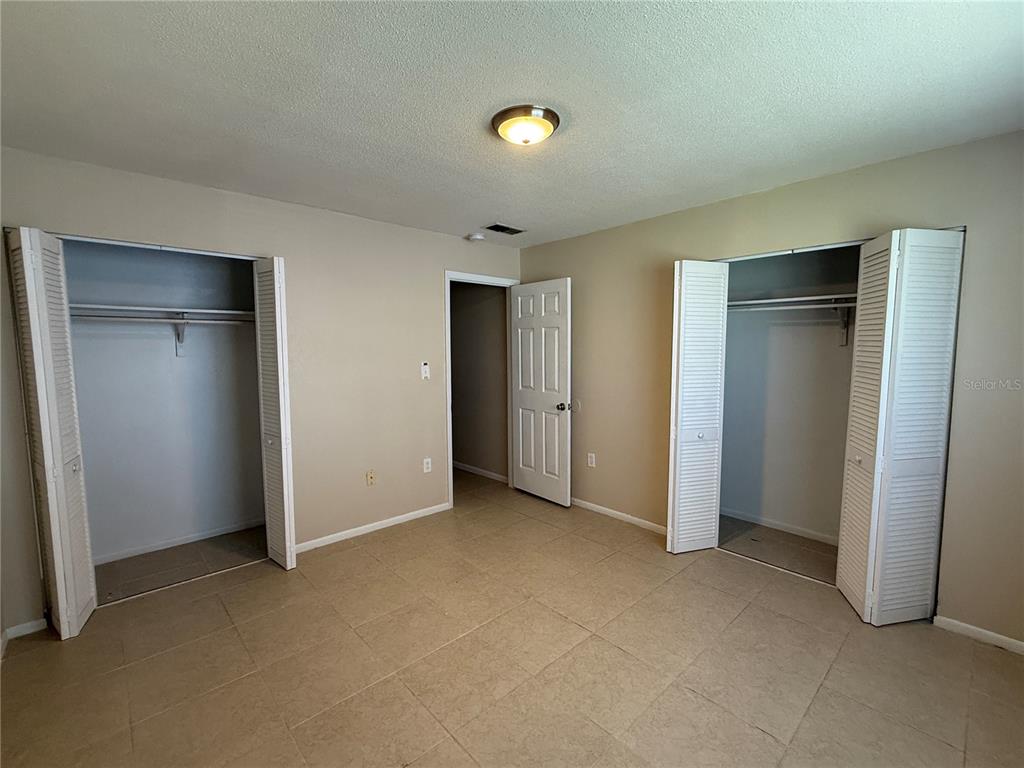 2744 Botts Landing Road, Unit 702 DeLand, FL 32720 - Photo 10 of 12 an empty room with closet and windows