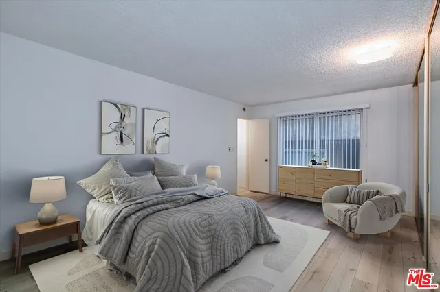 a bedroom with a bed and couch