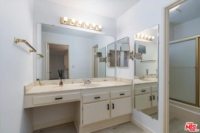 a bathroom with a granite countertop sink mirror and double