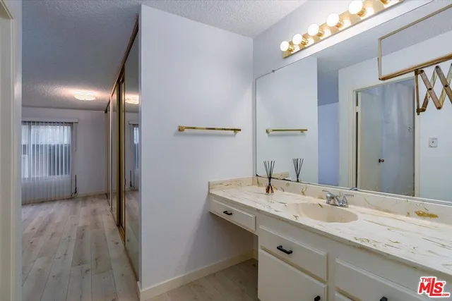 a bathroom with a sink a mirror and a shower