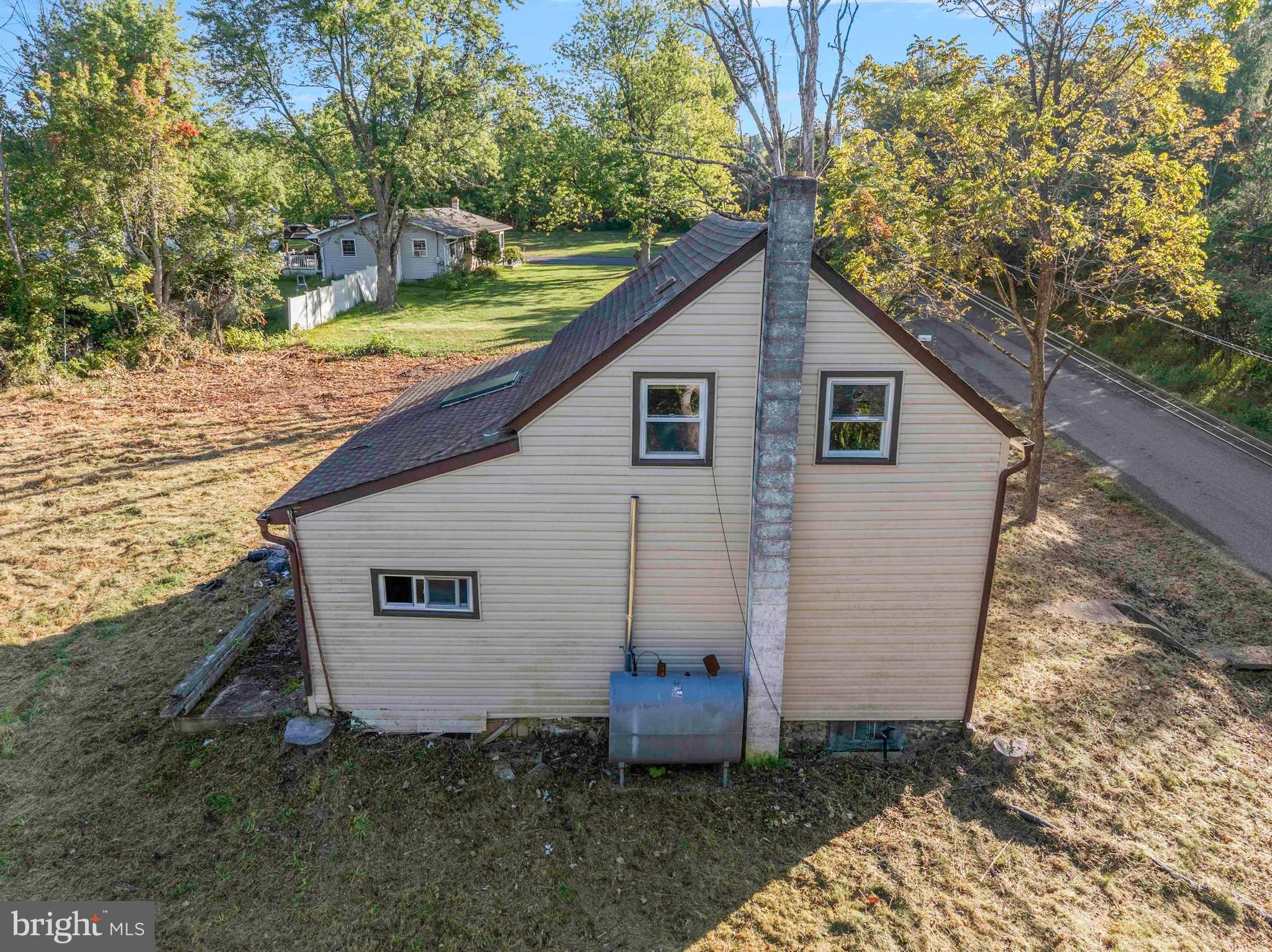 1270 Fennel Road Pennsburg, PA 18073 - Photo 9 of 18 a view of a backyard with plants and large tree