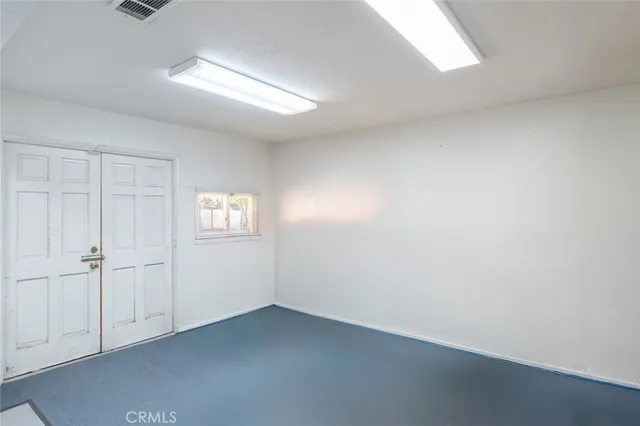 an empty room with a empty space and windows
