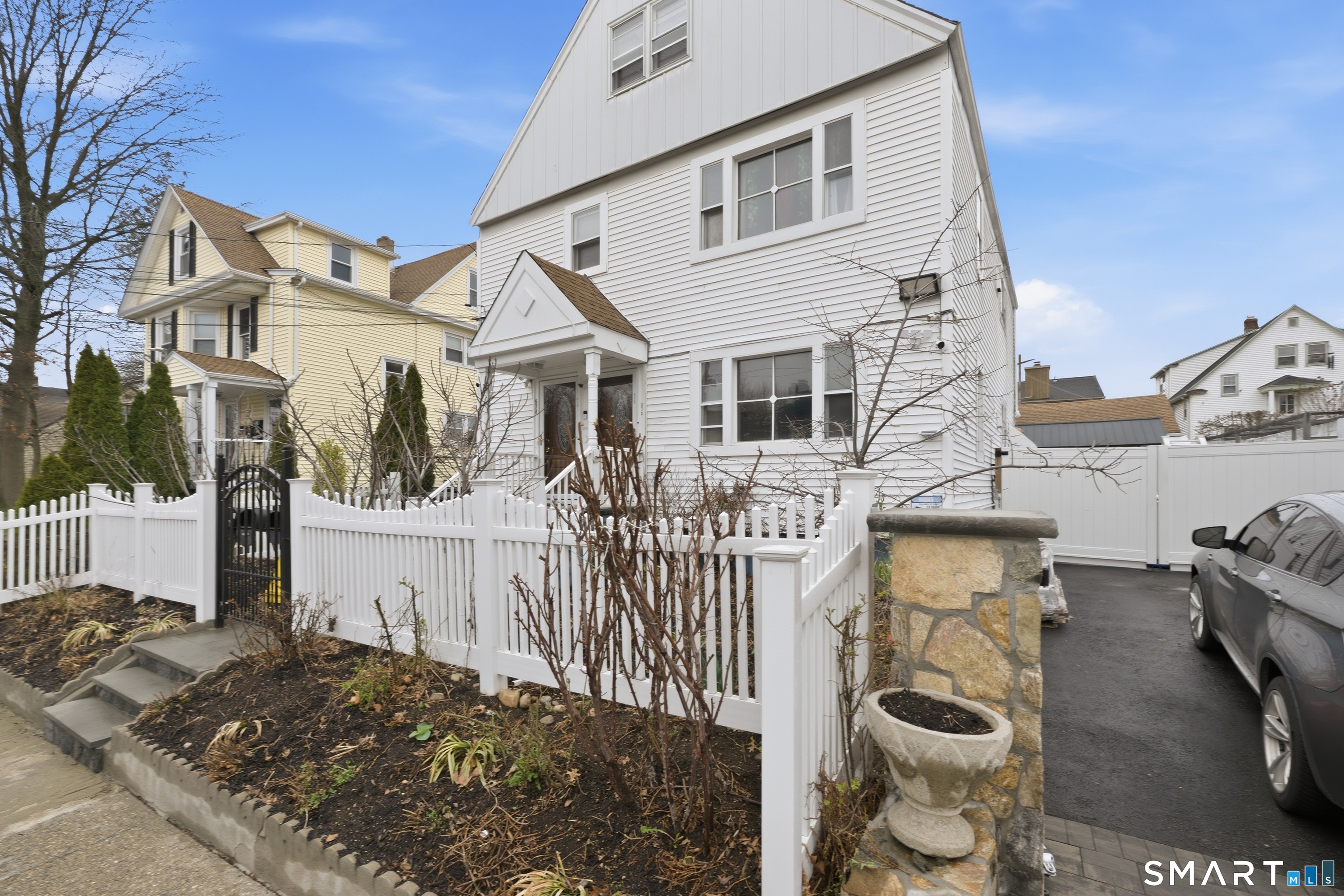 a view of a house with wooden fence
