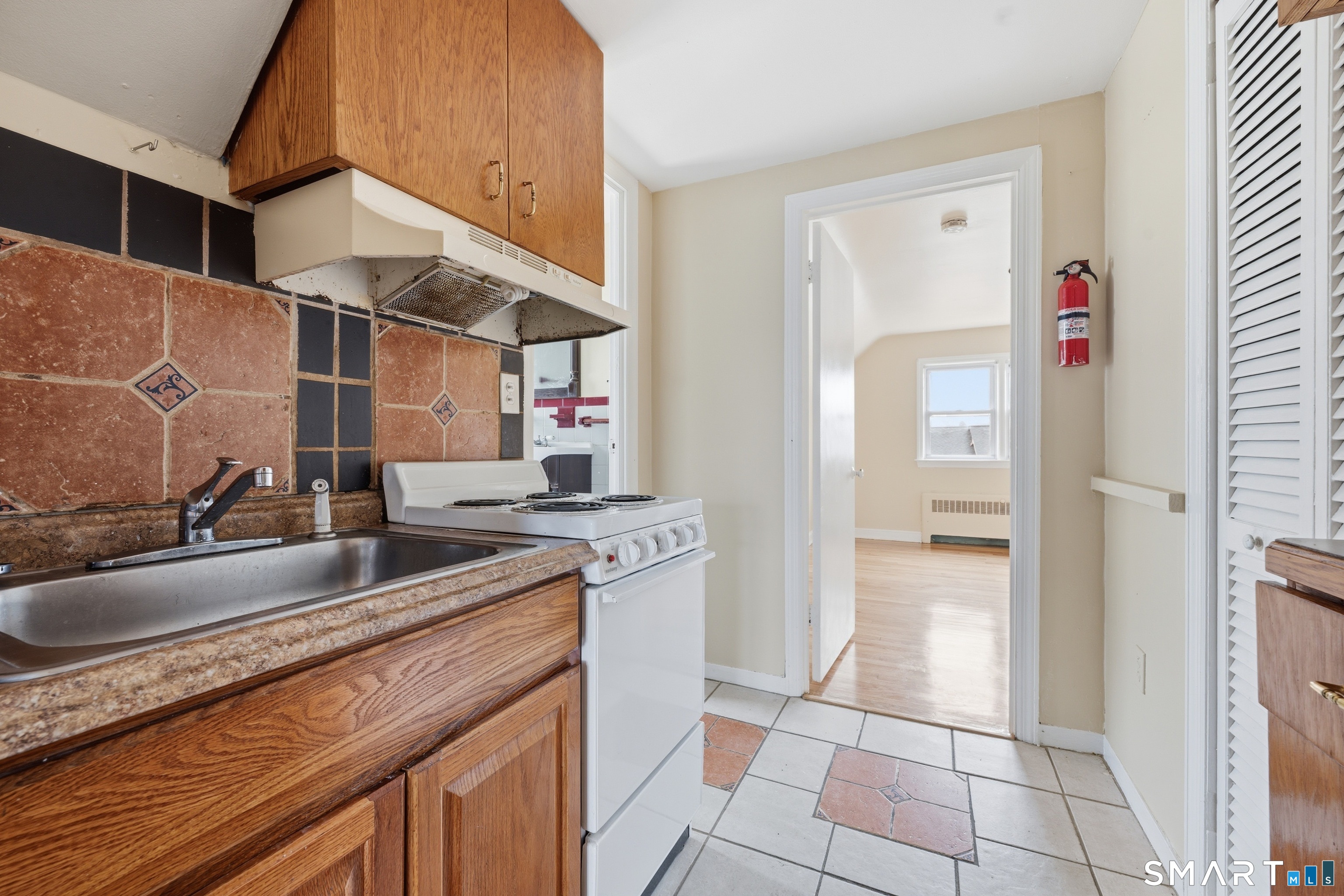 976 Capitol Avenue, Unit 3 Bridgeport, CT 06606 - Photo 6 of 12 a kitchen with stainless steel appliances granite countertop a sink and cabinets