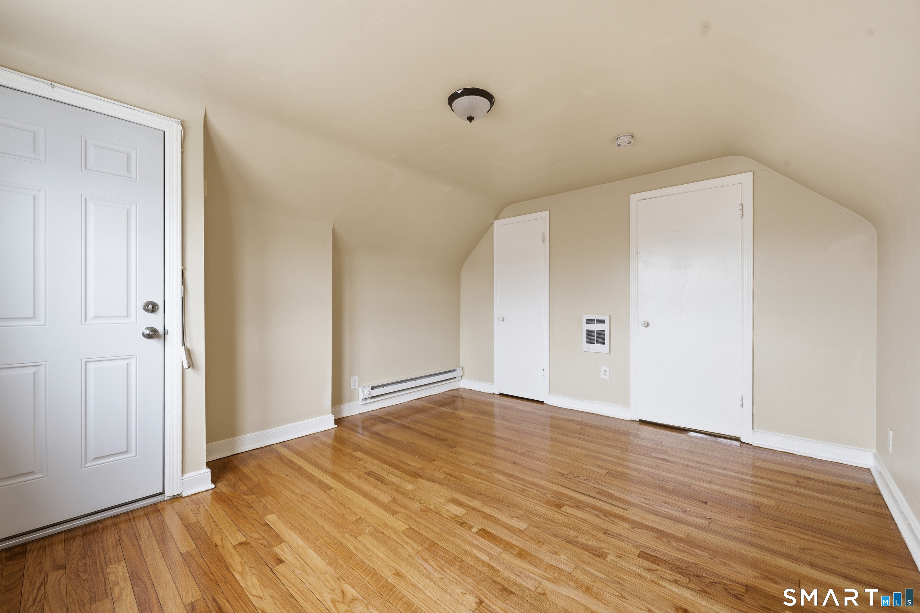976 Capitol Avenue, Unit 3 Bridgeport, CT 06606 - Photo 8 of 12 a view of an empty room with wooden floor