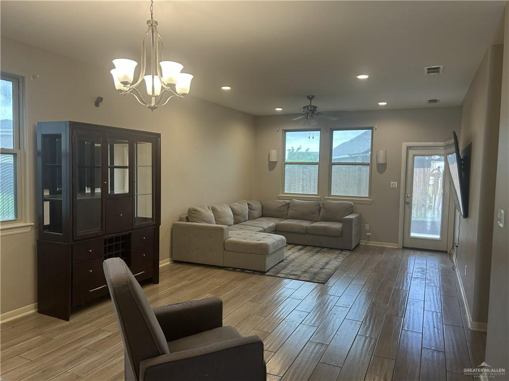6317 Cascada Bnd Road McAllen, TX 78504 - Photo 3 of 4 a living room with furniture wooden floor and a chandelier