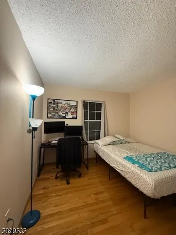 a bedroom with a bed and a desk