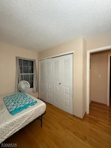 a bedroom with a bed and rug