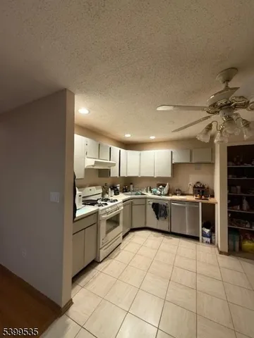 a kitchen with a sink stainless steel appliances and cabinets