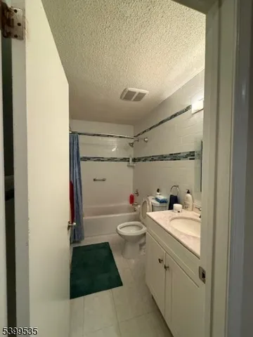 a bathroom with a double vanity sink toilet and shower