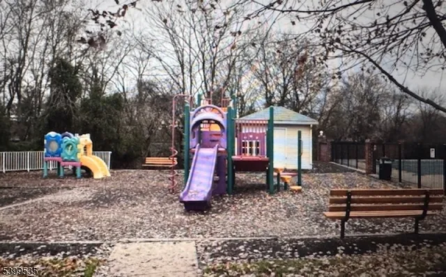 a childrens park with lots of swings and slides