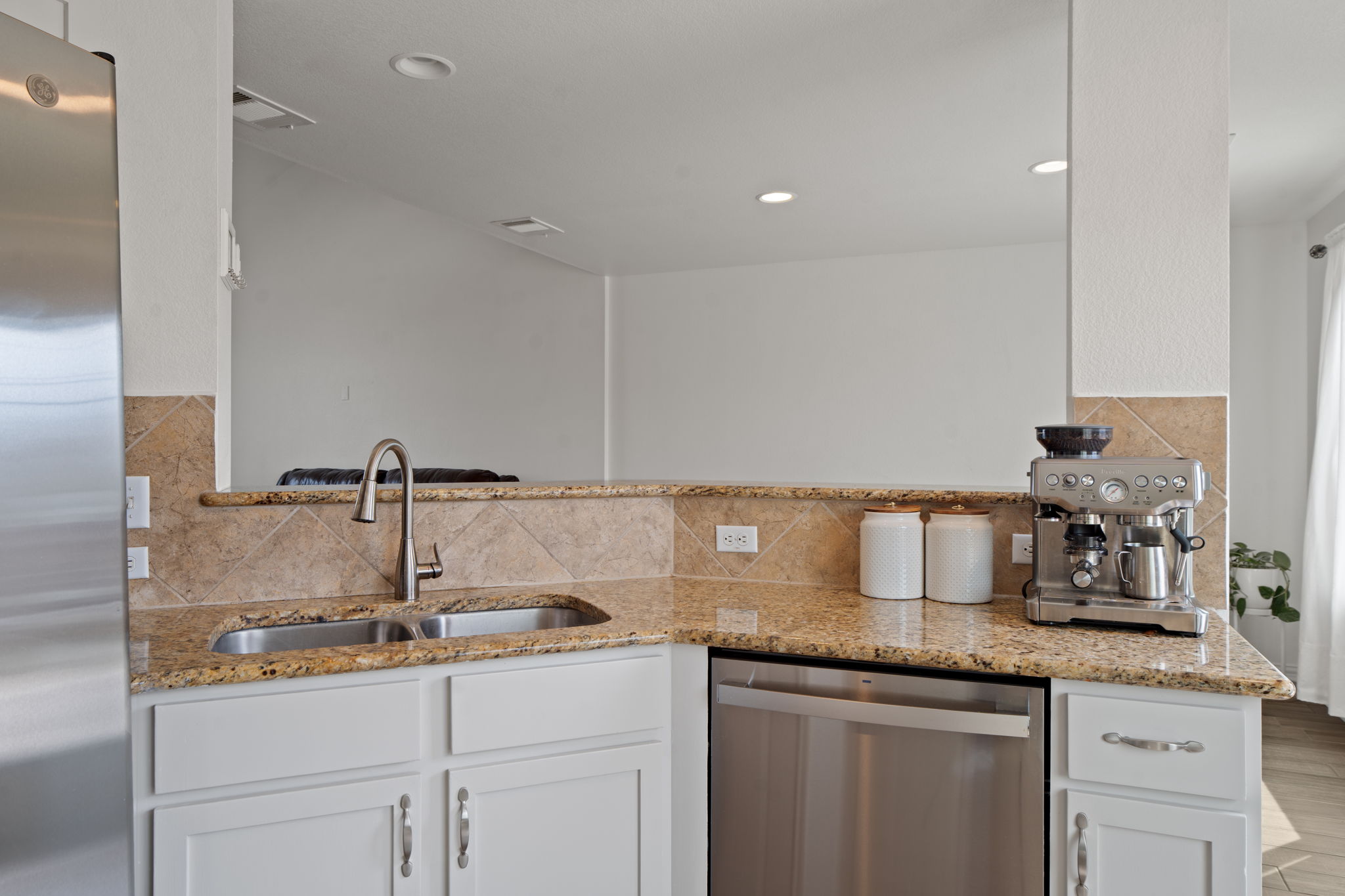 13109 Pealing Way Manor, TX 78653 - Photo 11 of 32 Kitchen featuring stainless steel appliances, light stone countertops, white cabinetry, backsplash, and recessed lighting