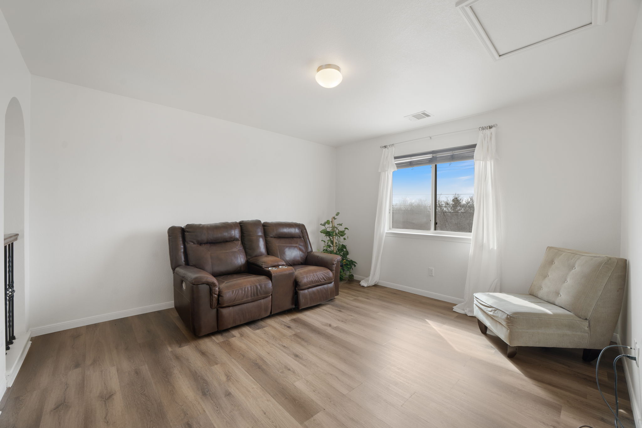 13109 Pealing Way Manor, TX 78653 - Photo 19 of 32 Sitting room featuring light wood finished floors and arched walkways