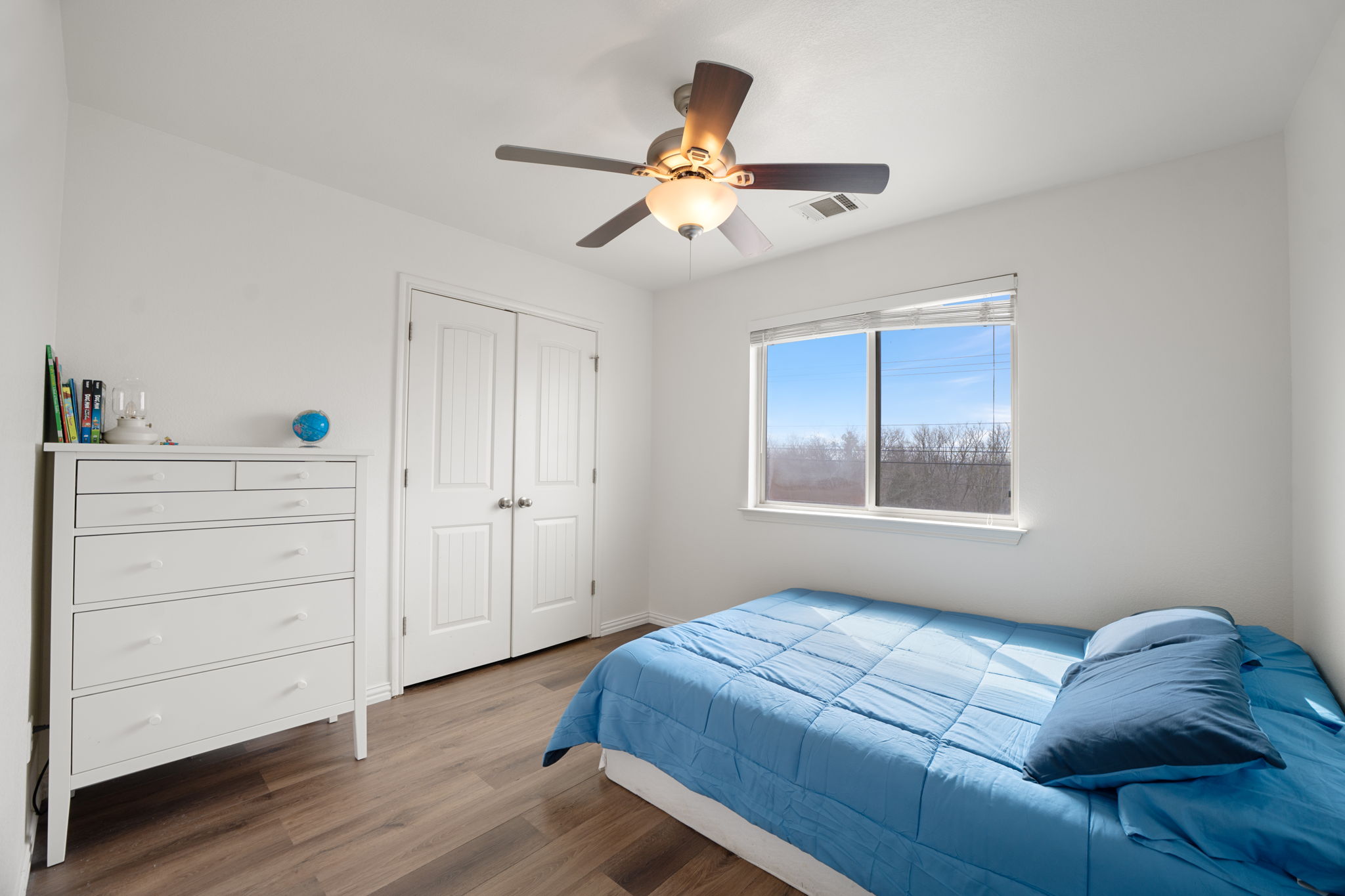 13109 Pealing Way Manor, TX 78653 - Photo 21 of 32 Bedroom with wood finished floors, ceiling fan, and a closet