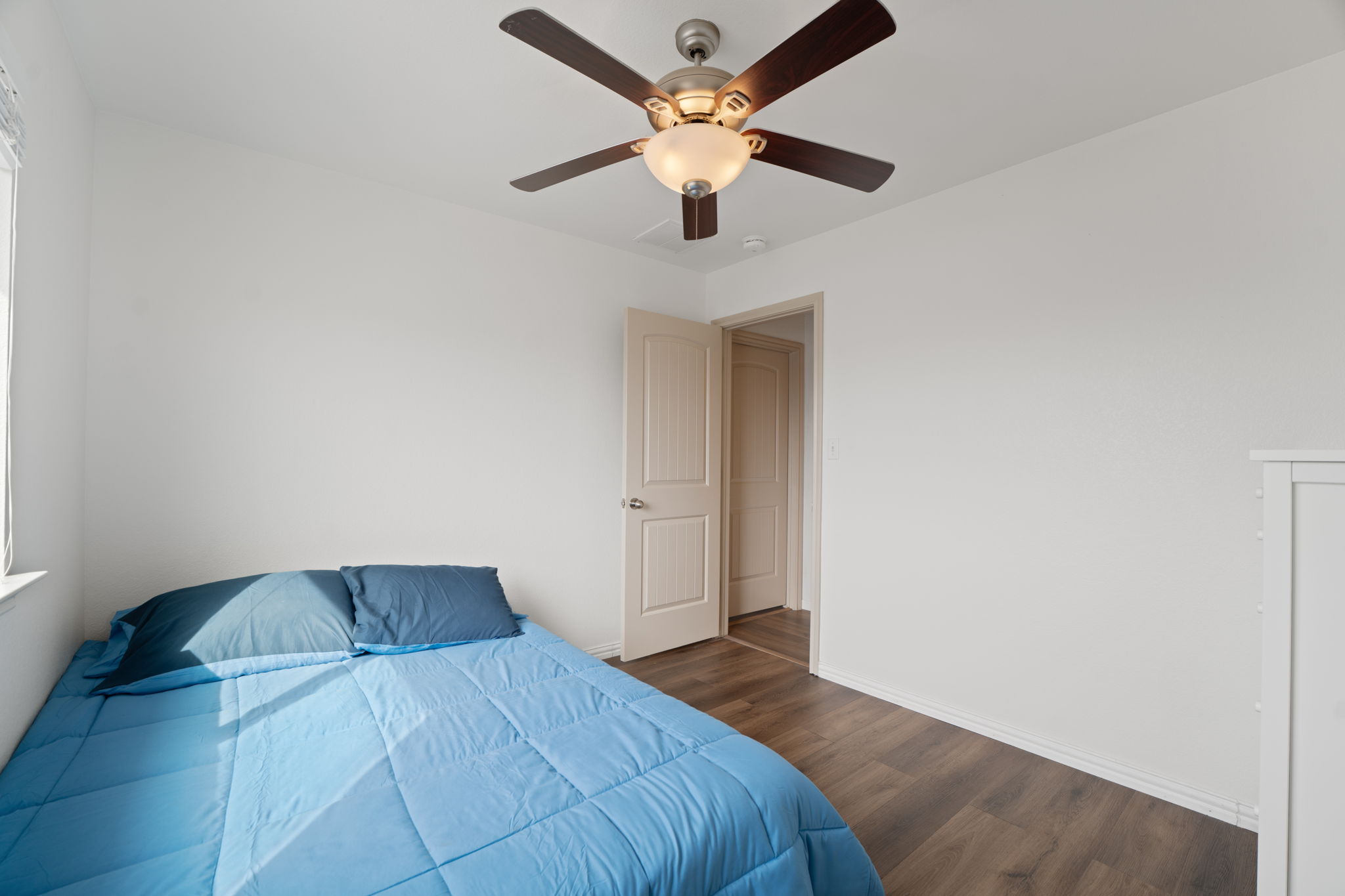 13109 Pealing Way Manor, TX 78653 - Photo 22 of 32 Bedroom with dark wood-style flooring and a ceiling fan
