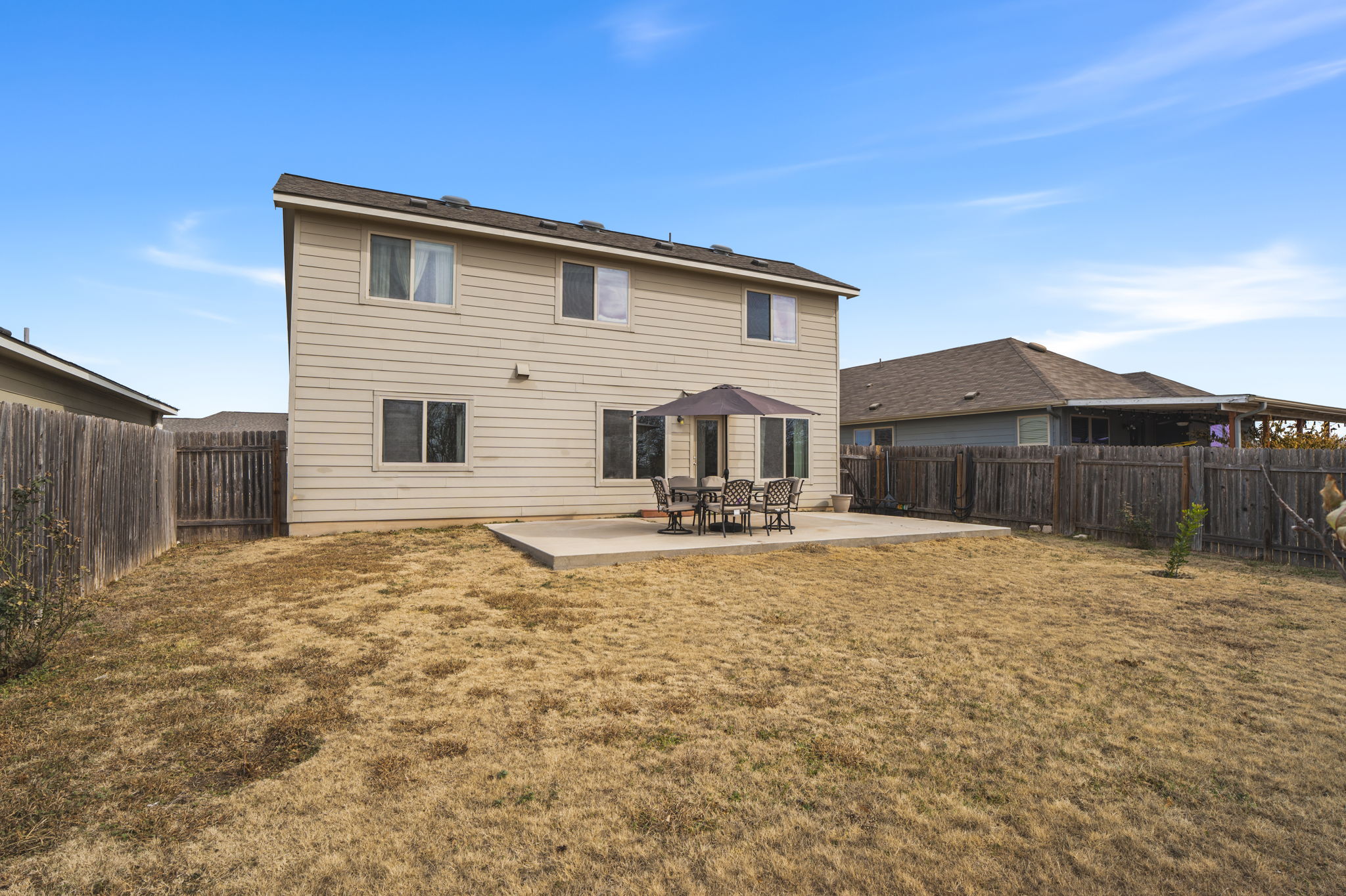 13109 Pealing Way Manor, TX 78653 - Photo 27 of 32 Rear view of house with a patio area and a fenced backyard