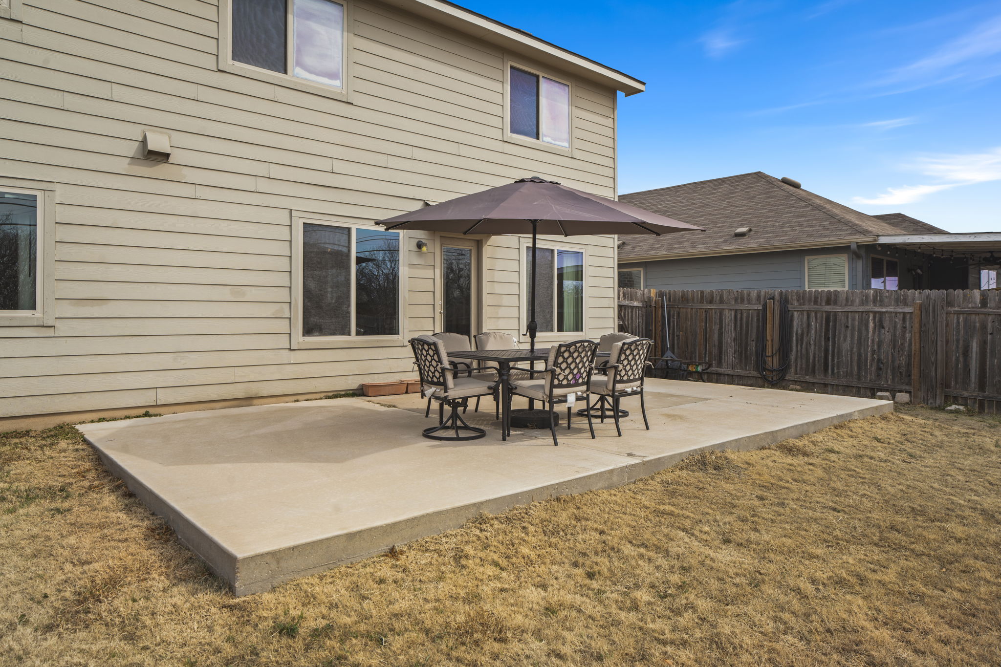 13109 Pealing Way Manor, TX 78653 - Photo 30 of 32 Rear view of property featuring a fenced backyard, a patio area, and outdoor dining area