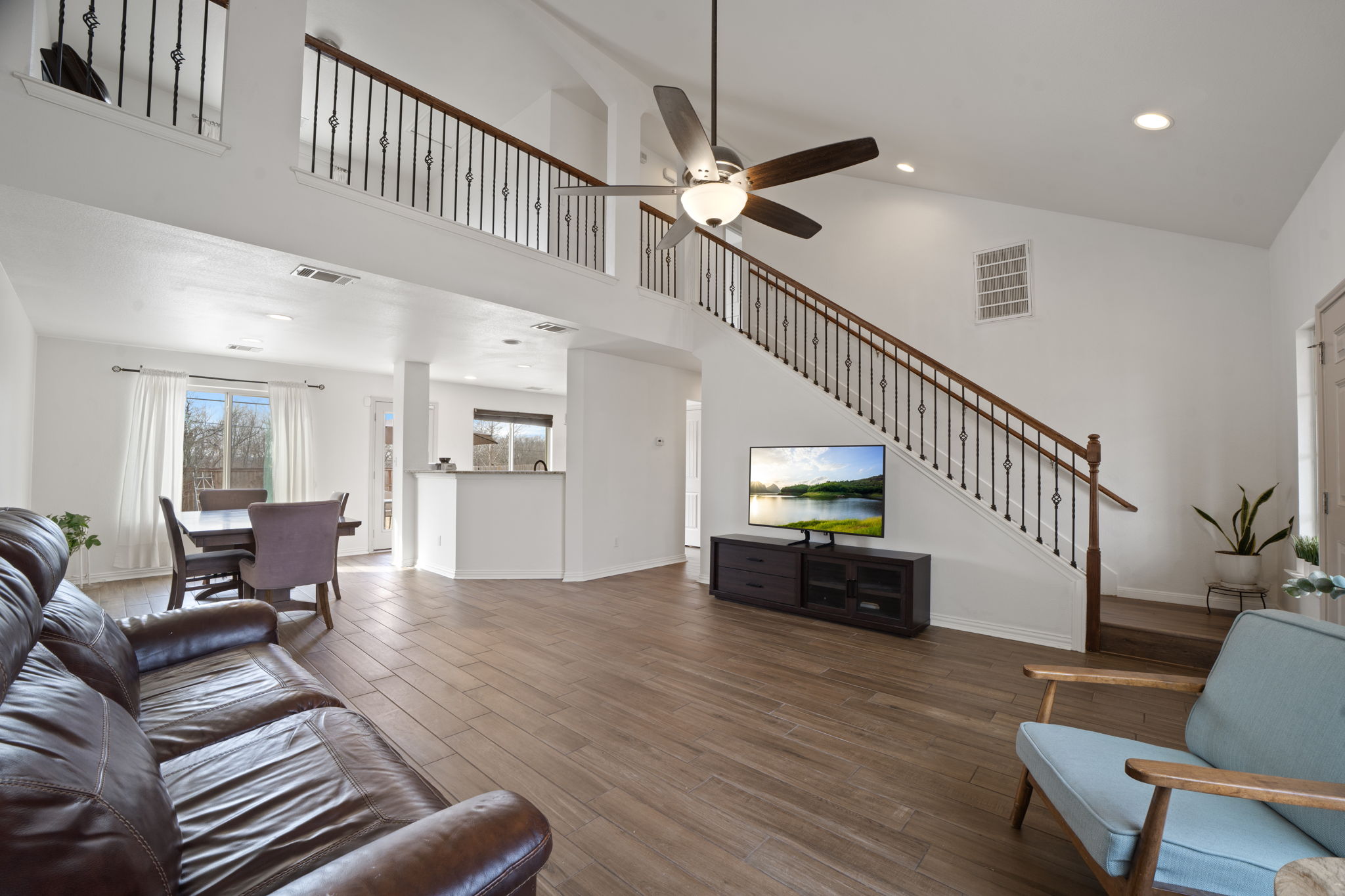 13109 Pealing Way Manor, TX 78653 - Photo 7 of 32 Living room with wood finished floors, ceiling fan, recessed lighting, and lofted ceiling