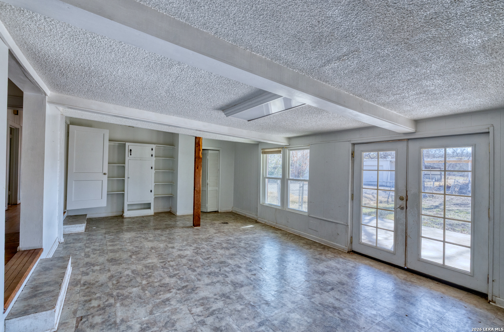 227 West Mueller Street Uvalde, TX 78801 - Photo 13 of 27 an empty room with windows