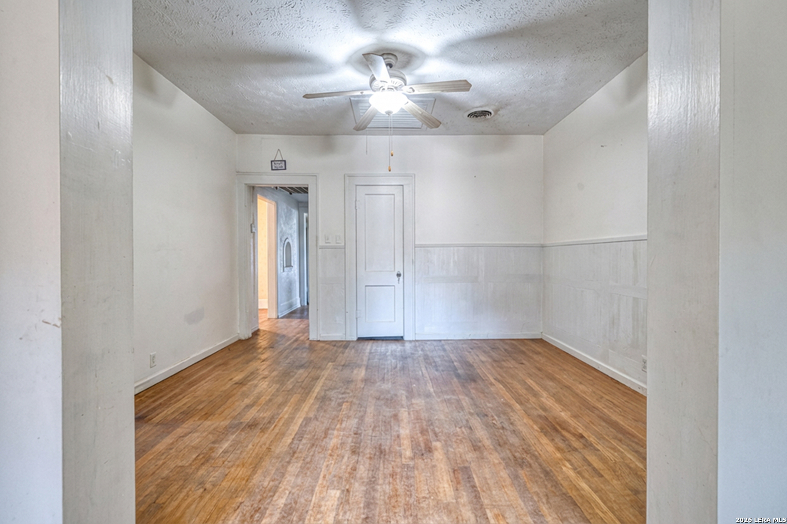227 West Mueller Street Uvalde, TX 78801 - Photo 14 of 27 wooden floor in an empty room