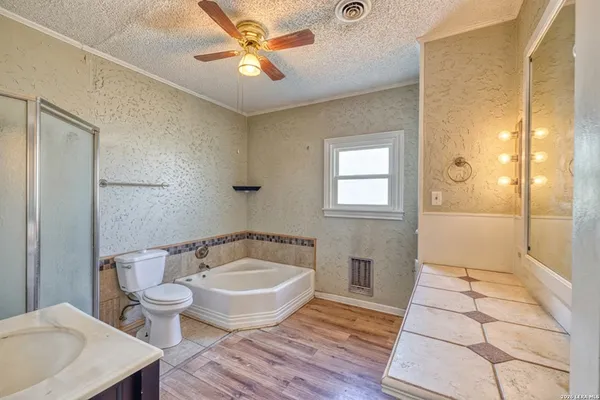 a spacious bathroom with a bathtub and shower