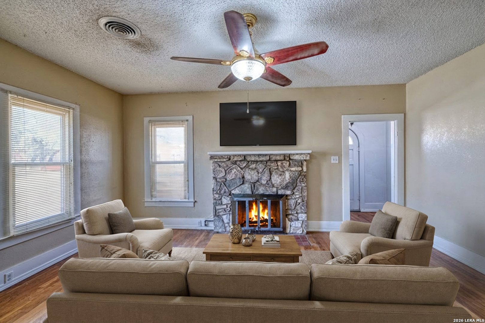 227 West Mueller Street Uvalde, TX 78801 - Photo 5 of 27 a living room with furniture and a fireplace