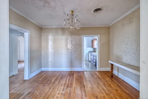 a view of an empty room and wooden floor