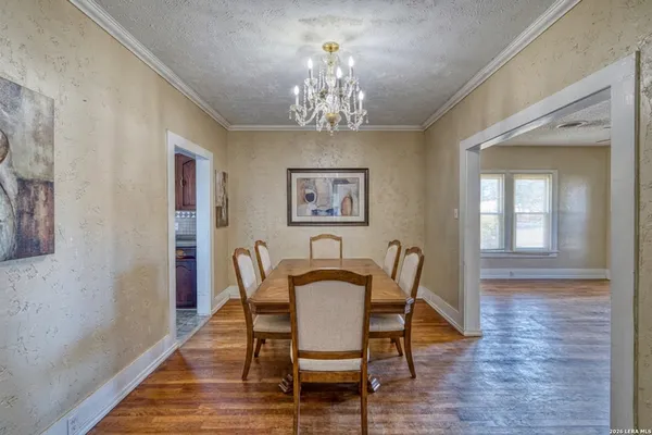 a view of a dining room with furniture wooden floor and chandelier