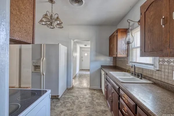 a bathroom with a granite countertop sink a large mirror and a shower