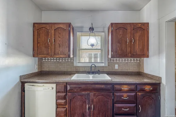 a sink with a wooden cabinets