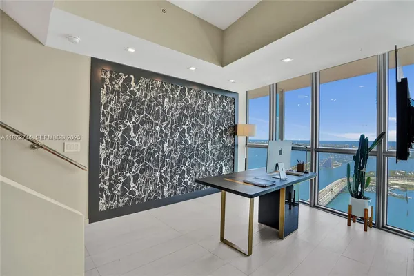 a living room with furniture and large windows